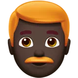 Man: Dark Skin Tone, Red Hair — Apple