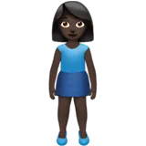 Woman Standing: Dark Skin Tone — Apple